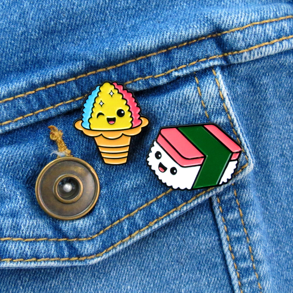 Spam Musubi and Shaved Ice enamel pins on jean jacket pocket