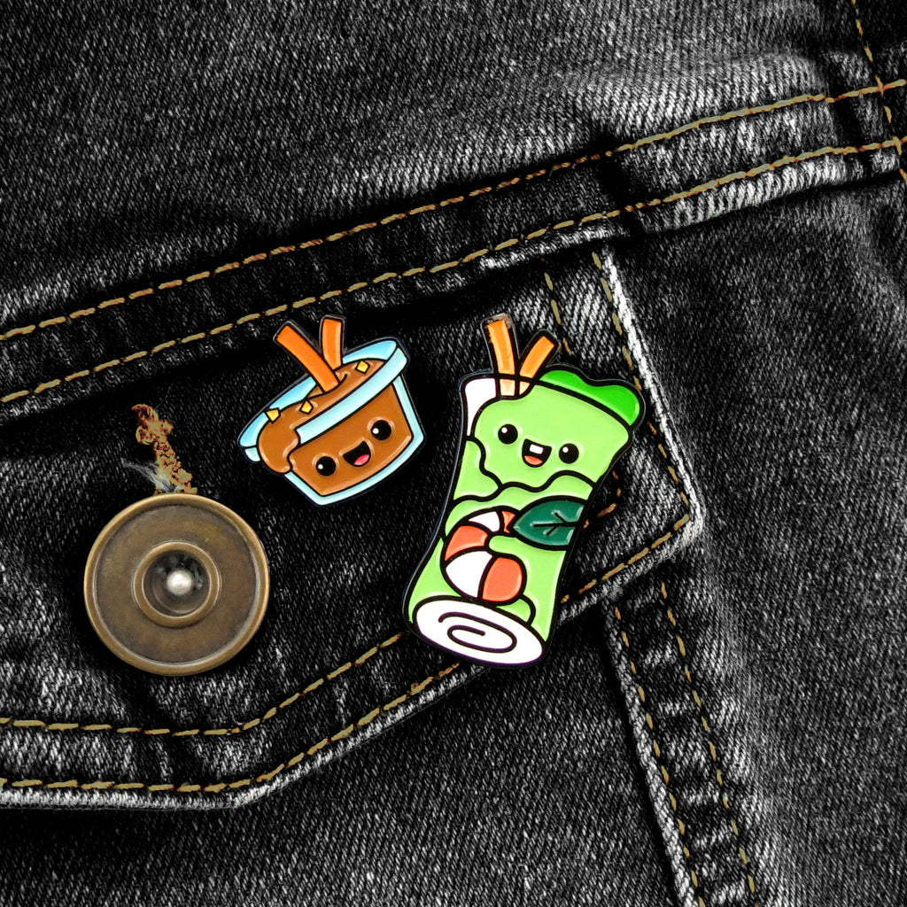 Spring Roll and Peanut Sauce enamel pins on black jean jacket